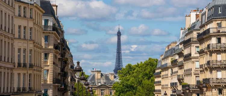 Eiffel tower between Parisian tenement old street alley and buildings