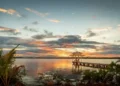 Sunset view of a pier with a bungalow in the Caribbean. choose to retire in the Caribbean