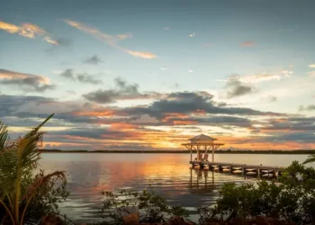 Sunset view of a pier with a bungalow in the Caribbean. choose to retire in the Caribbean