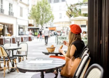 A Paris restaurant with a woman wearing a red beret