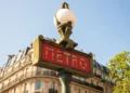 A traditional Paris Metro sign with buildings in the background. Europe Cities