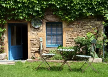 Sunny day in a cottage garden with chairs and table