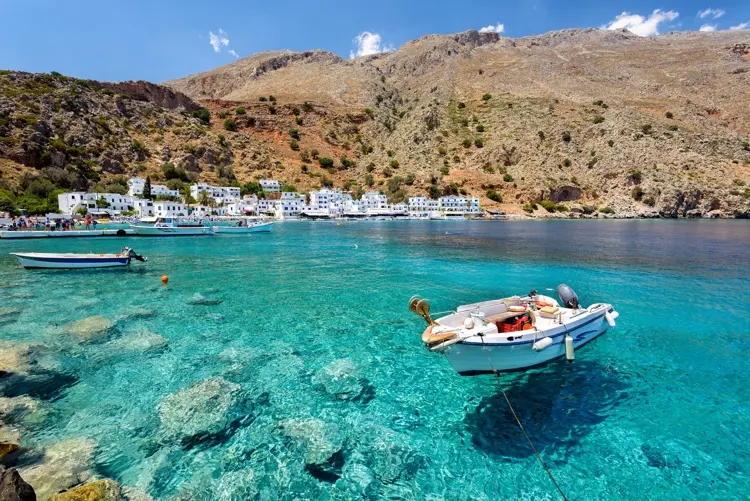 Small motorboat at clear water bay of Loutro town on Crete island, Greece