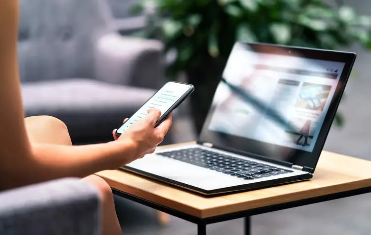 Woman using smartphone and modern notebook. work in belize