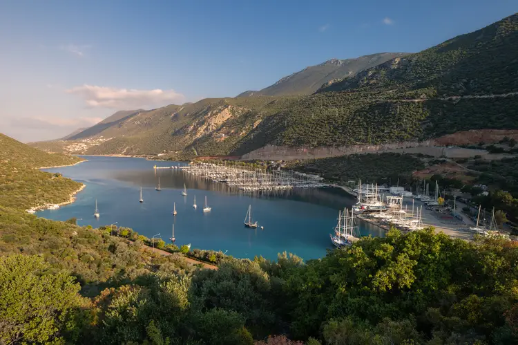 Panoramic landscape of a lagoon and marina full of sail boats between forested mountains, Kas, Turkey. kas