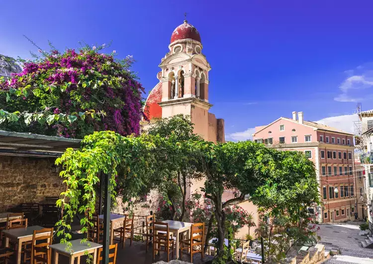 Street with cafe and flowers, in the island of Corfu