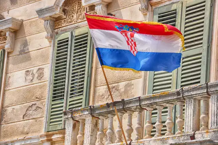 Old building in Croatia with a flag.