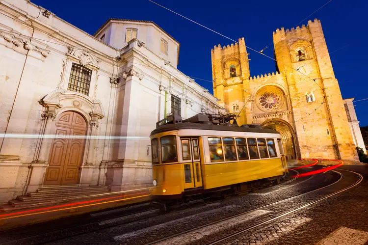 Tram in front of the Lisbon Cathedral at night. portugal lisbon