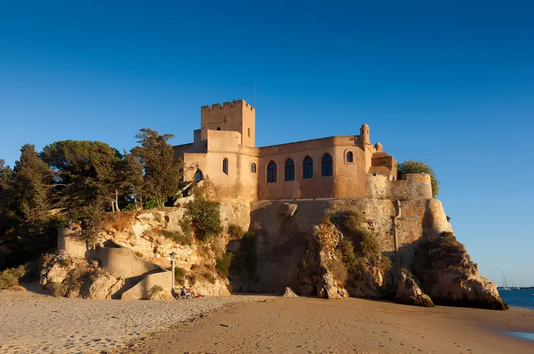 Blue skies in Algarve, Portugal. View of the Castle of Ferragudo