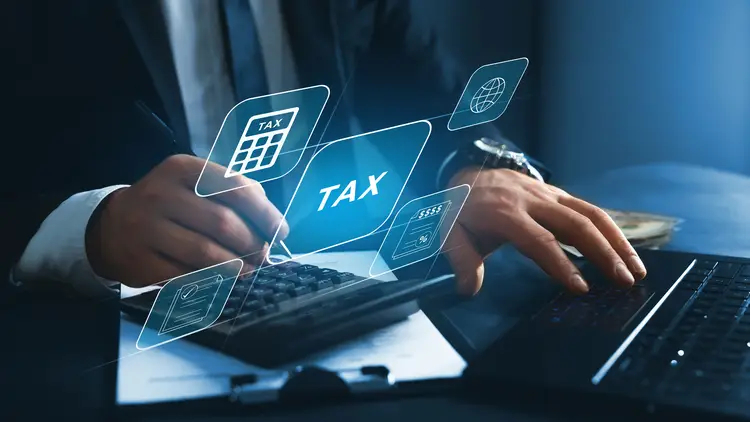 Businessman using the laptop to fill in the income tax online return form for payment. taxes in france