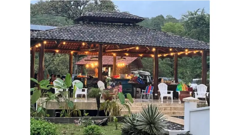 Panama Jack’s tiki bar at Los Islotes, an open-air gathering space with tropical charm, ambient lighting, and scenic garden surroundings.