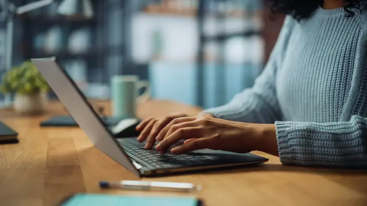 Close Up on Hands of a Female Specialist Working on Laptop. work in italy