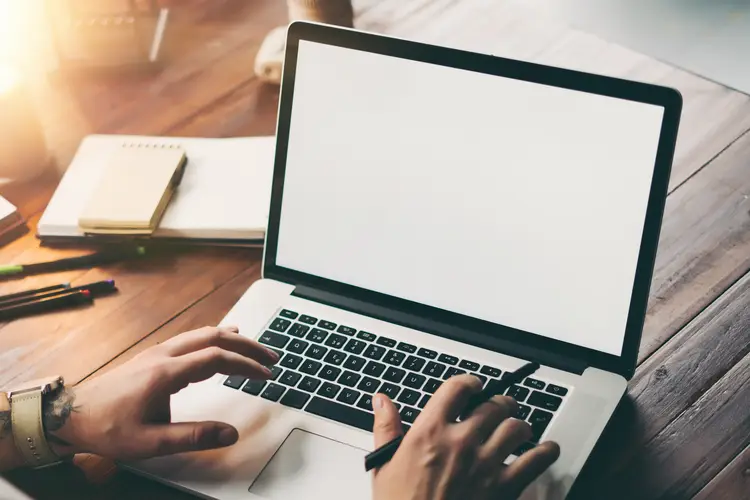 Close up of male hands and laptop with blank screen. work in chile