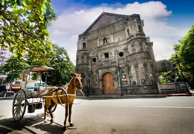 Horse Drawn Carriage parking in front of Malate church , Manila. climate in Philippines