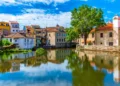 Old buildings in Viseu reflected on a local creek, Portugal