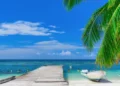 A wooden bridge juts out into of the sea in The Dominican Republic