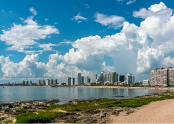 Tourist walking on Rambla (street) Claudio Wiliman towards a beach of Punta Del Este, Uruguay, January 28th 2019