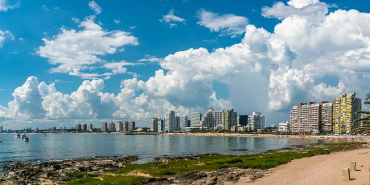 Tourist walking on Rambla (street) Claudio Wiliman towards a beach of Punta Del Este, Uruguay, January 28th 2019