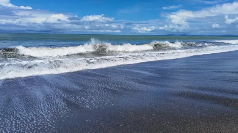 Rolling waves and blue skies at a beach in Mariato