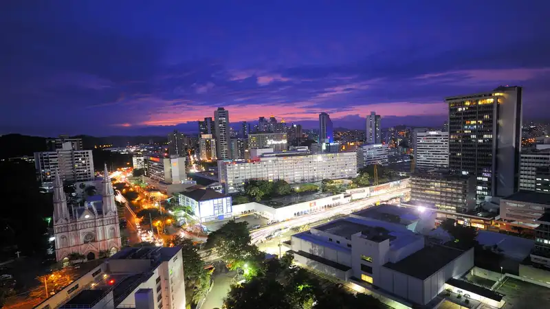 A view of one of Panama City's (Panama) neighborhoods, named El Cangrejo. Picture taken at dusk (aka the "blue hour") in June of 2012. El Cangrejo is mainly a residential neighborhood and it is famous for its Panama Hotel, depicted on the foreground. move to panama