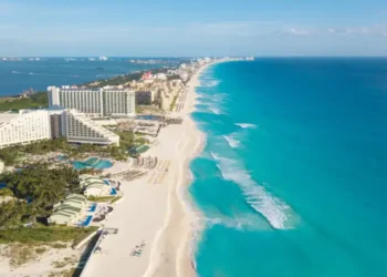 Cancun aerial view. Zona hotelera Cancun beach panorama top view. Caribbean seaside beach with turquoise water and big waves. Yucatan, Quintana Roo, Mexico