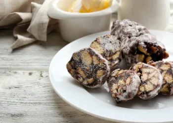 Chocolate salami in a plate over wooden background