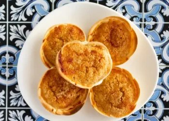 Traditional Portuguese pastry called Queijada de Sintra on portuguese tiles background