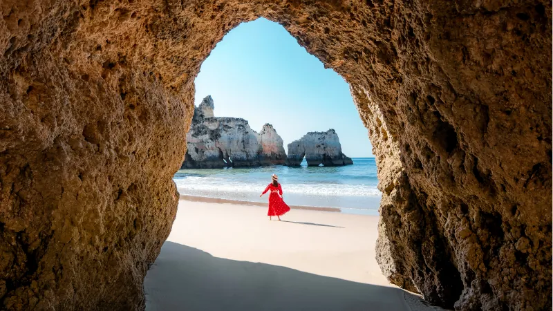Traveler woman enjoying alone the beaches of the Algarve, Portugal