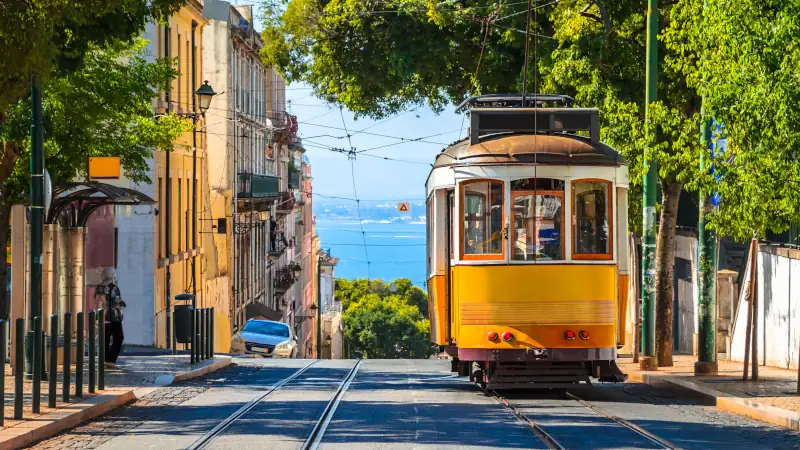Famous yellow vintage tram in the street of Alfama, Lisbon, Portugal