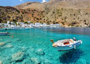 Small motorboat at clear water bay of Loutro town on Crete island, Greece