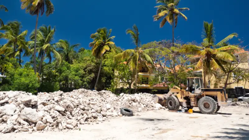 Excavator on construction site with pile of stones
