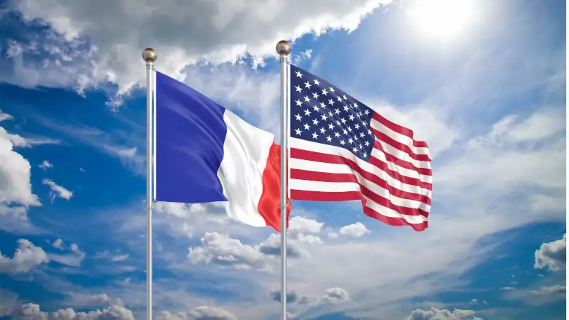 United States of America vs France. Thick colored silky flags of America and France.