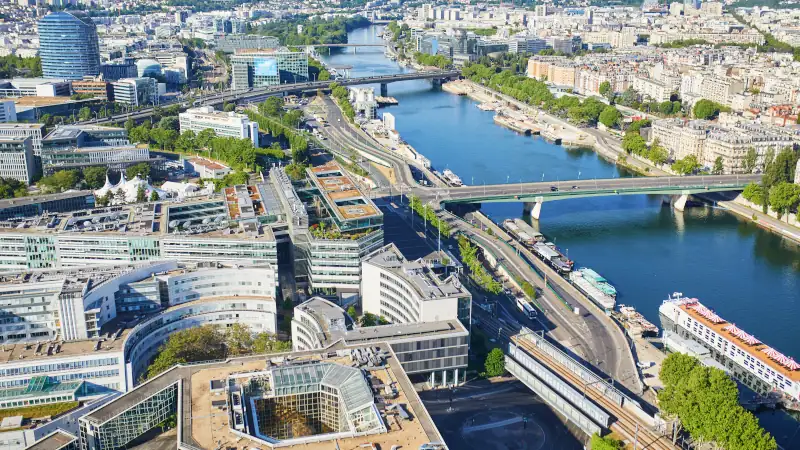 Aerial panoramic view of the Seine River and modern architecture in the western part of Paris on a sunny day