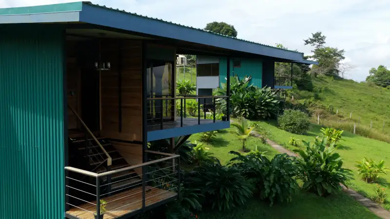 Modern architectural eco lodges integrated into the lush green landscape of a sustainable resort in costa rica, offering a serene nature retreat