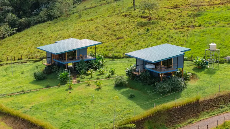 Modern bungalows nestled on green hillside in costa rica