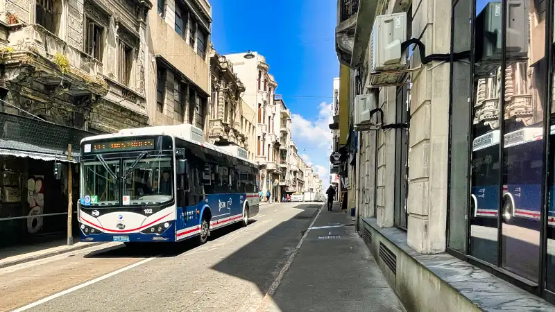 public transport bus is driving on the street in the ciudad vieja transporting people