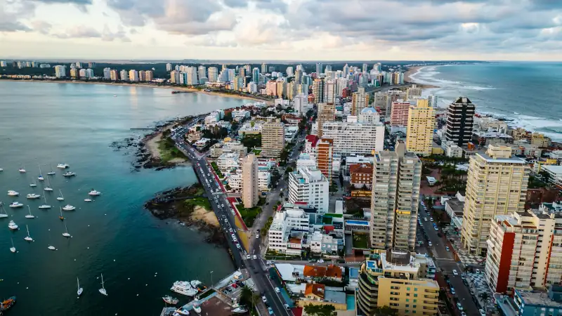 Aerial of Punta del Este Uruguay with cityscape drone fly above scenic skyline with modern skyscraper buildings