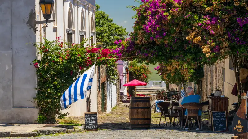 Small cobblestone street leading to river with restaurant in Colonia del Sacramento Uruguay