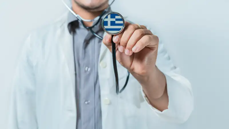 Greece national healthcare. Doctor showing stethoscope with Greece flag