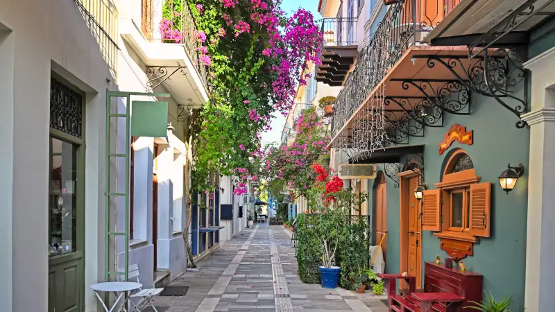 Narrow streets of Nafplion town with Bougainvillea flowers