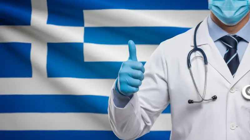 Trust Greek healthcare, a masked doctor gives a thumbs up for quality care near the Greek flag