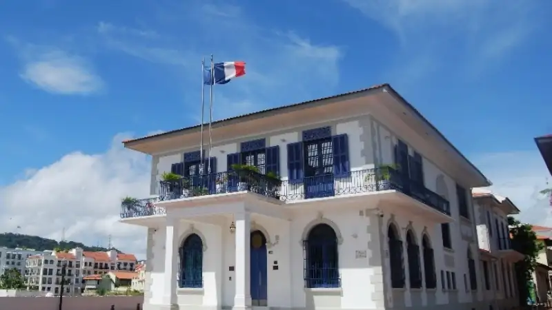 Historic French-style building in Panama City with blue shutters and balconies.