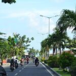 Motorcycles and cars on a bust street in Bali, Indonesia