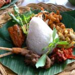 a typical Indonesian plate with rish and vegetables and chicken