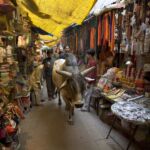 A cow walking through a market in India