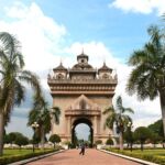 An arch over a wide sidewalk in Laos