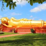 A gold reclining buddha statue in Laos