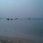 Fishing boats bob in the ocean, Cambodia.