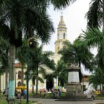 A church looks over the plaza in a small Colombian town.