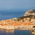 Red tile roofs contrast with the blue ocean in Croatia.